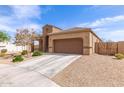 Beautiful single-story home with a two-car garage, desert landscaping, and a cozy porch at 19887 N Herbert Ave, Maricopa, AZ 85138