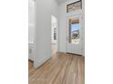 Bright entryway with wood floors, white walls, and a view of the front yard through a glass door at 20302 W Turney Ave, Buckeye, AZ 85396