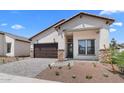 Beautiful single-Gathering home showcasing stone accents, desert landscaping and a two-car garage at 20302 W Turney Ave, Buckeye, AZ 85396