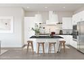 Bright, eat-in kitchen featuring white cabinets, stainless steel appliances, and a large center island at 20302 W Turney Ave, Buckeye, AZ 85396