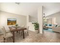 Dining area with modern table set and decor, seamlessly connecting to the living space at 21840 N 41St St, Phoenix, AZ 85050