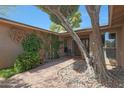 Inviting front entrance with a brick walkway, desert landscaping, and a cozy seating area at 25639 S Beech Creek Dr, Sun Lakes, AZ 85248