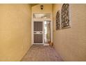 Welcoming entryway with decorative ironwork, tiled flooring, and a security door at 2882 N 155Th Dr, Goodyear, AZ 85395