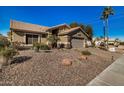 Exterior of home featuring desert landscaping, a paved driveway, two-car garage and blue sky at 2882 N 155Th Dr, Goodyear, AZ 85395