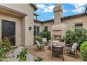 Charming courtyard with a fireplace, comfortable seating, and lush greenery, creating a relaxing outdoor space at 30129 N 52Nd Pl, Cave Creek, AZ 85331