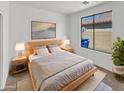Cozy bedroom with natural light, a comfortable bed, and minimalist decor for restful nights at 3013 S 102Nd Ln, Tolleson, AZ 85353