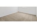 Neutral bedroom with beige carpet, white walls, and natural light at 37126 W Prado St, Maricopa, AZ 85138