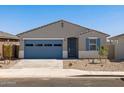 Charming single-story home featuring a blue garage door and desert landscaping at 37126 W Prado St, Maricopa, AZ 85138