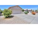 Single-story home featuring a two-car garage, low-maintenance landscaping and tile roof at 426 N Santiago Trl, Casa Grande, AZ 85194