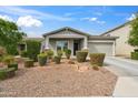 Inviting single-Gathering home featuring desert landscaping, a well-manicured front yard, and a cozy front porch at 460 W Glacier Bay Dr, San Tan Valley, AZ 85140