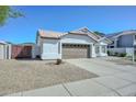 Charming home featuring a well-manicured front yard, two-car garage, desert landscaping and a mountain backdrop at 5226 W Pontiac Dr, Glendale, AZ 85308