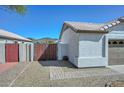 Charming home featuring a well-manicured front yard, desert landscaping, brick pathway and wooden gate at 5226 W Pontiac Dr, Glendale, AZ 85308