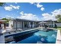 Stunning backyard pool with lounge chairs, covered patio, and well-maintained landscaping at 5809 N 10Th Pl, Phoenix, AZ 85014