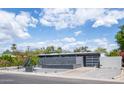 Modern home exterior with a gray color scheme and landscaped front yard at 5809 N 10Th Pl, Phoenix, AZ 85014
