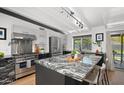 Modern kitchen boasts a granite island, stainless steel appliances, and sleek cabinetry at 5809 N 10Th Pl, Phoenix, AZ 85014