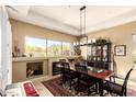 Dining room featuring a large window with mountain views, elegant decor and a fireplace at 6094 E Evening Glow Dr, Scottsdale, AZ 85266