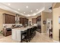 Spacious kitchen with an oversized island, stainless appliances, and ample dark wood cabinetry at 6094 E Evening Glow Dr, Scottsdale, AZ 85266