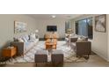 Bright living room offers stylish furniture, hardwood flooring, and an area rug for a warm and inviting atmosphere at 6602 S 23Rd Ave, Phoenix, AZ 85041