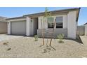 Attractive single-story home featuring desert landscaping and a modern design with a two-car garage at 9543 W Parkway Dr, Tolleson, AZ 85353