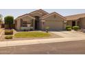 Charming single-story home with a desert landscape and well-maintained front yard at 10621 W Pima St, Tolleson, AZ 85353