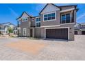Beautiful new construction home with a two-car garage and stylish exterior at 11300 N Casa Dega Dr # 1027, Surprise, AZ 85388