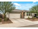 Charming single-story home with a well-maintained front yard and a two-car garage at 12374 W Locust Ln, Avondale, AZ 85323