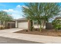 Charming single-story home with a well-maintained front yard and a two-car garage at 12374 W Locust Ln, Avondale, AZ 85323