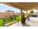 Spacious backyard showcasing a patio, lush green turf, a well-maintained garden, and outdoor play area for  at 12425 W Willow Ave, El Mirage, AZ 85335