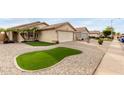 Attractive single-story home featuring desert landscaping, a two-car garage, and a well-maintained lawn at 12425 W Willow Ave, El Mirage, AZ 85335