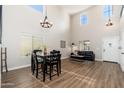 Bright living room with high ceilings, wood floors, and modern furnishings provides an open and airy atmosphere at 14095 W Larkspur Dr, Surprise, AZ 85379