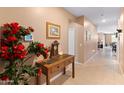Inviting hallway with console table, stylish decor, and view into the living spaces at 14166 W Valentine St, Surprise, AZ 85379