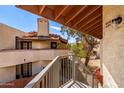 Exterior view from a stairwell highlighting the desert-style architecture, tile roof and stucco finish of this building at 16402 N 31St St # 232, Phoenix, AZ 85032