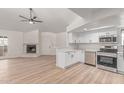 Spacious living room features an open concept kitchen with white cabinets and stainless steel appliances at 16402 N 31St St # 232, Phoenix, AZ 85032