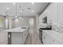 Bright kitchen features a spacious island, stainless steel appliances, and sleek white cabinetry at 16945 W Vernon Ave, Goodyear, AZ 85395