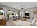Bright living room features large windows, neutral tones, and stylish furniture arrangement at 16945 W Vernon Ave, Goodyear, AZ 85395