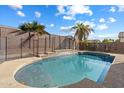 Refreshing backyard pool with decorative tile and safety fence, surrounded by desert landscaping and sunny skies at 18585 E Ryan Rd, Queen Creek, AZ 85142