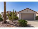 Inviting single-story home with desert landscaping, a two-car garage, and a neutral color scheme at 19740 N Wind Rose Way, Surprise, AZ 85374