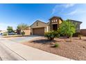 A single-Gathering home featuring low-maintenance landscaping, a two-car garage, and a charming facade at 23789 W Chipman Rd, Buckeye, AZ 85326