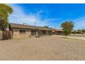 View of single story brick home with gravel front yard and blue skies at 2808 W Lawrence Rd, Phoenix, AZ 85017