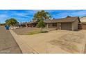 Brick single story home featuring a gravel front yard and concrete driveway at 2808 W Lawrence Rd, Phoenix, AZ 85017