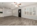 Bright living room with tiled floor, ceiling fan, and ample natural light at 2808 W Lawrence Rd, Phoenix, AZ 85017
