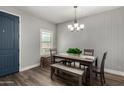 Cozy dining area with a gray table and bench, highlighted by stylish wallpaper and natural light from a window at 2821 S Skyline -- # 135, Mesa, AZ 85212
