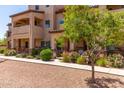 Inviting townhome featuring an arched entryway and landscaped front yard with manicured shrubs at 2821 S Skyline -- # 135, Mesa, AZ 85212