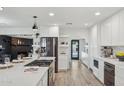 Modern kitchen featuring stainless steel appliances, a large island, and sleek white cabinetry at 3009 E Whitton Ave, Phoenix, AZ 85016