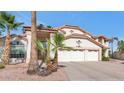 Two-story home showcasing a three-car garage, landscaped yard and a mature palm tree at 3112 N 110Th Ave, Avondale, AZ 85392
