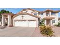 Two-story home showcasing a three-car garage, neutral color palette, and well-maintained landscaping at 3112 N 110Th Ave, Avondale, AZ 85392