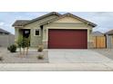Charming single-story home featuring a two-car garage, landscaped front yard, and a welcoming entrance at 323 S San Fernando Ln, Casa Grande, AZ 85194