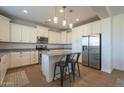 Beautiful kitchen with white cabinetry, stainless steel appliances, and a center island with seating at 3247 N Loma Vis, Mesa, AZ 85213