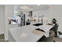 This bright kitchen has stainless steel appliances, an island, and quartz countertops at 3401 N 37 St # 14, Phoenix, AZ 85018