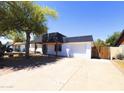 Single-story home with a long driveway, an RV gate, desert landscaping, and an attached garage at 3514 W Altadena Ave, Phoenix, AZ 85029